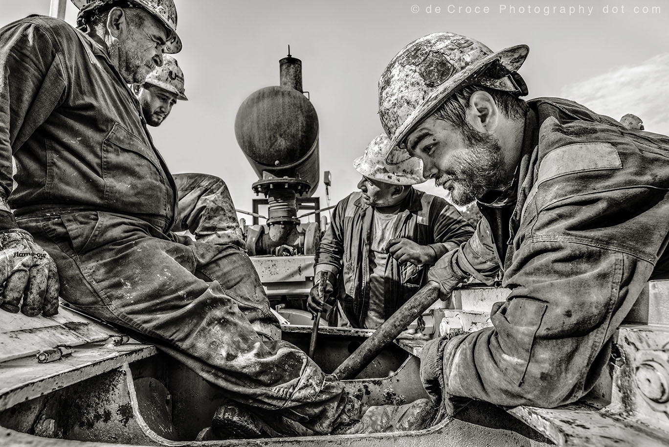 Black and white photo of roughnecks at work
