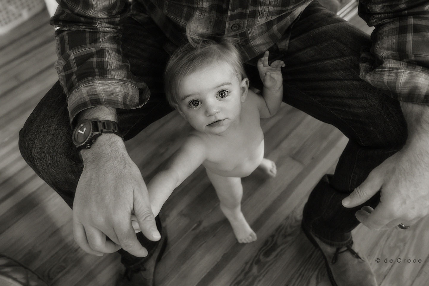 Black and white toddler in papa's hands