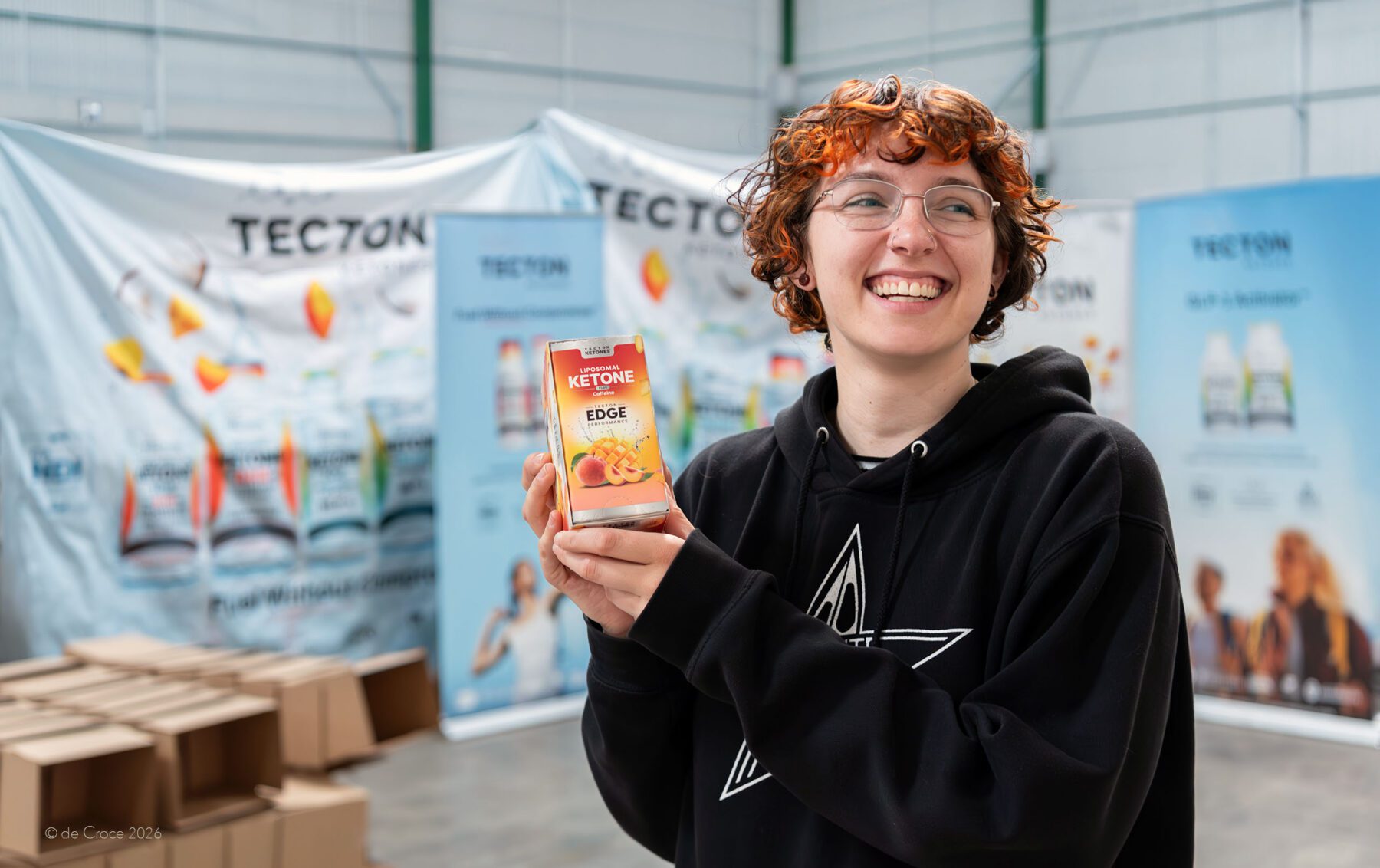 Advertising product photography in Denver Colorado shows young entrepreneur holding her product.