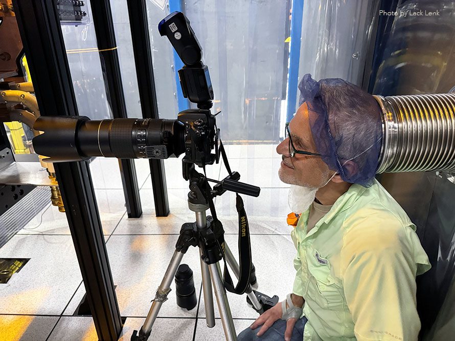 Colorado industrial photographer Edward DeCroce at work in "clean room" at Xcimer Energy in Denver.