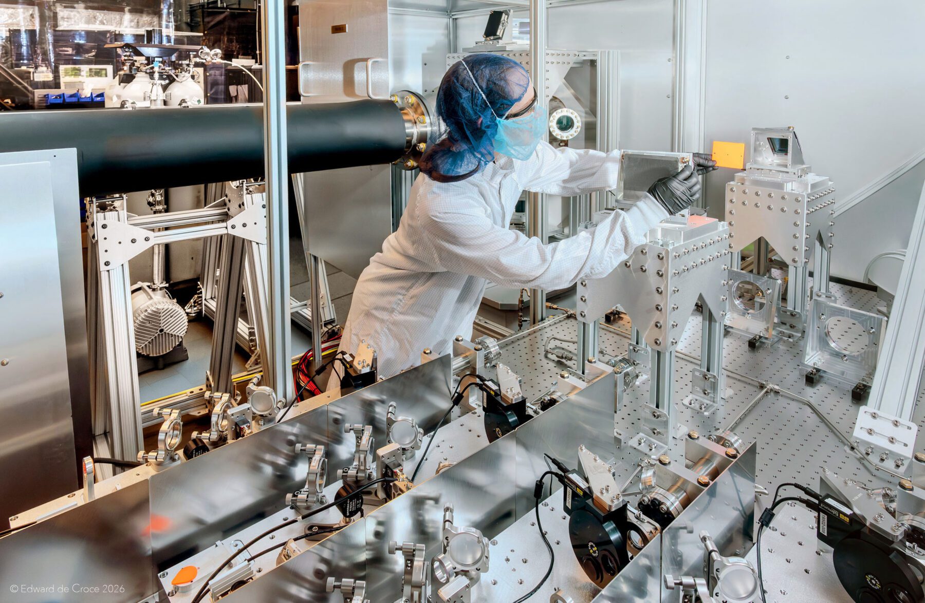 Advertising photographer in Denver for Xcimer Energy captures laser research imagery of female engineer.