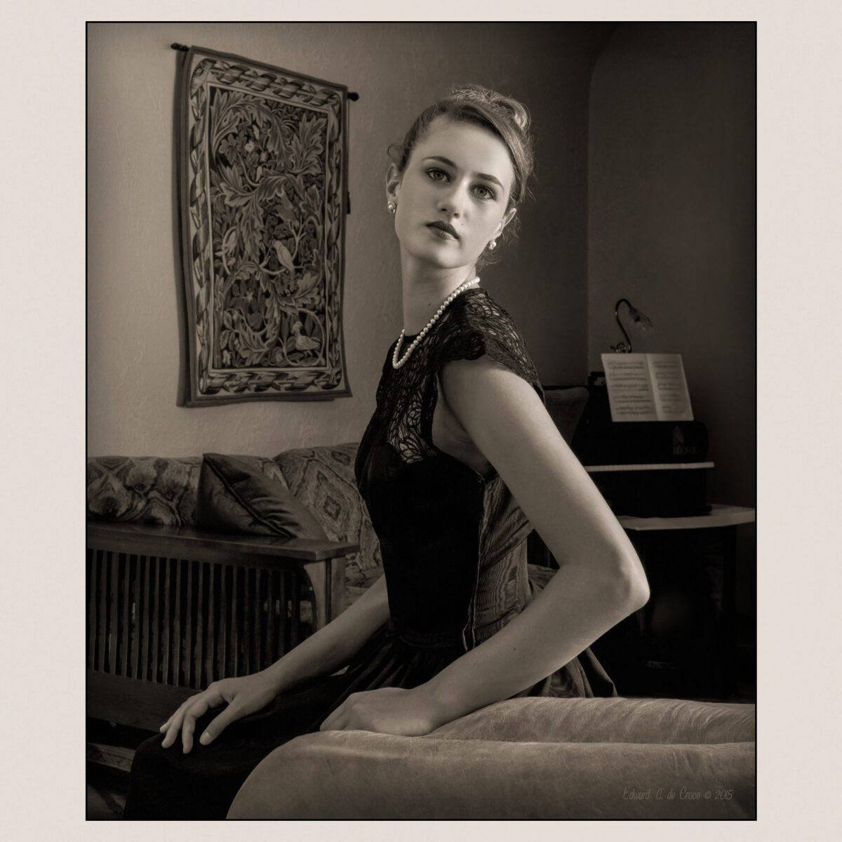 The darling portrait of a young woman in home in vintage sepia was created by Denver portrait artist photographer, Edward C. deCroce